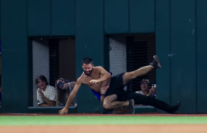Jun 16, 2023; Arlington, Texas, USA; A fan is tackled by security during the game between the Texas Rangers and Toronto Blue Jays at Globe Life Field. Mandatory Credit: Kevin Jairaj-USA TODAY Sports